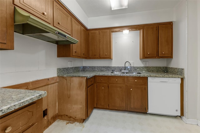 kitchen featuring white dishwasher, light stone counters, and sink