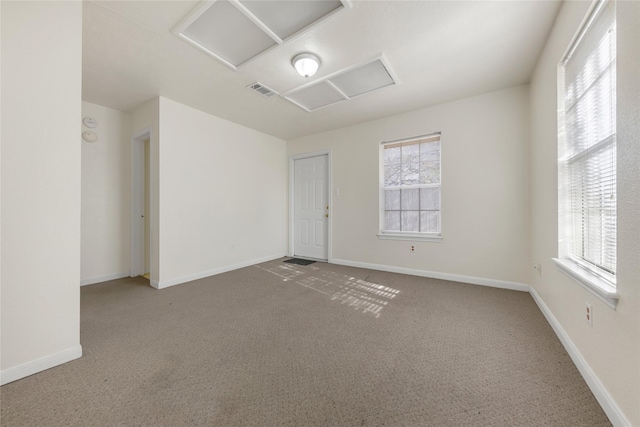 spare room featuring carpet floors and a wealth of natural light