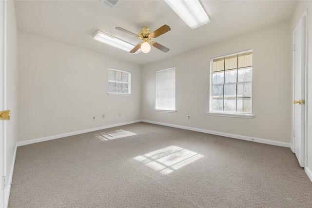 unfurnished room with ceiling fan and light carpet