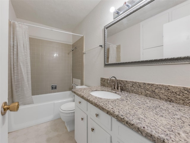 full bathroom featuring shower / bath combo, vanity, a textured ceiling, and toilet