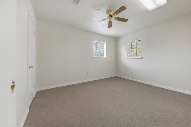 unfurnished room featuring ceiling fan and carpet