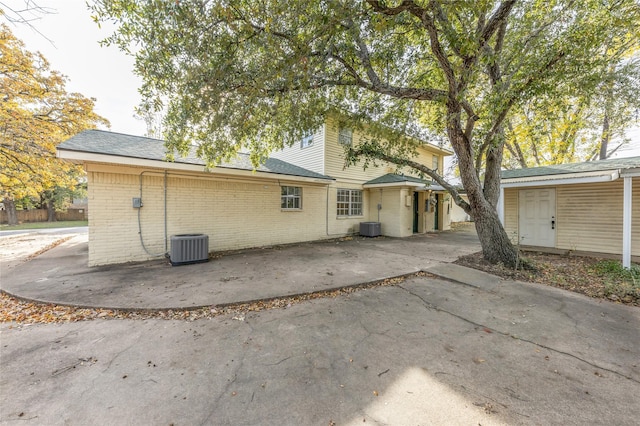 rear view of house featuring central AC unit