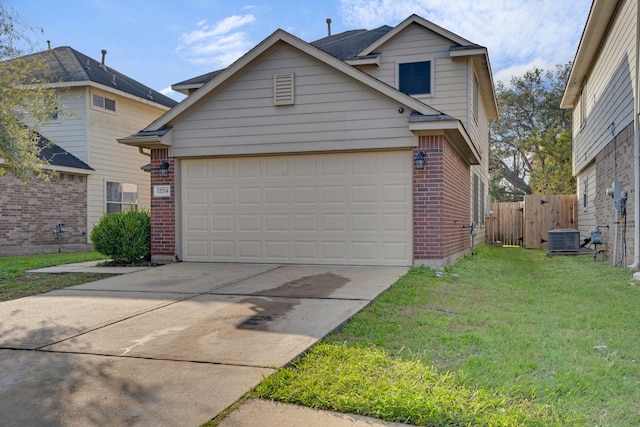 view of front facade featuring a garage, a front lawn, and central air condition unit