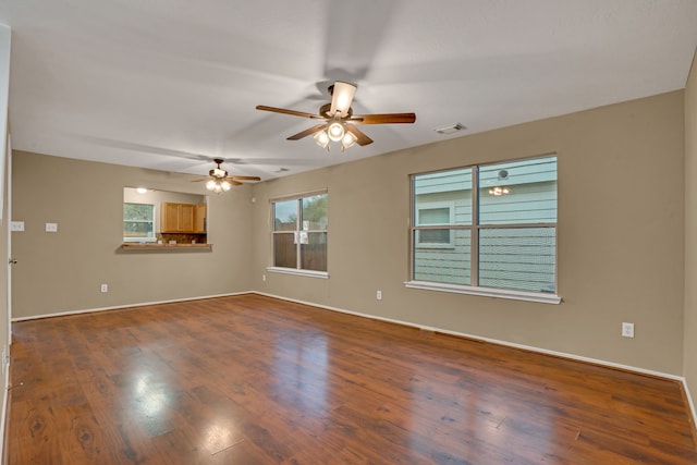 spare room with ceiling fan and dark wood-type flooring