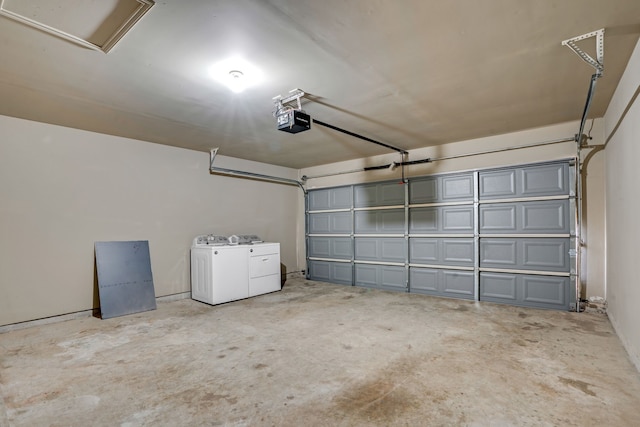 garage with a garage door opener and washing machine and clothes dryer