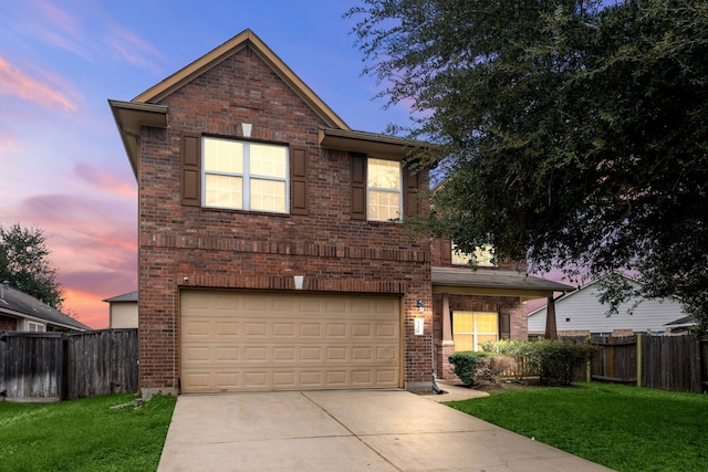 view of front property featuring a garage and a yard