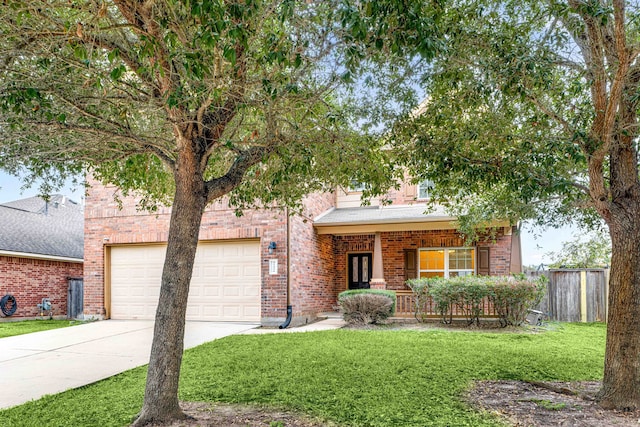 view of front of home featuring a front yard, a porch, and a garage