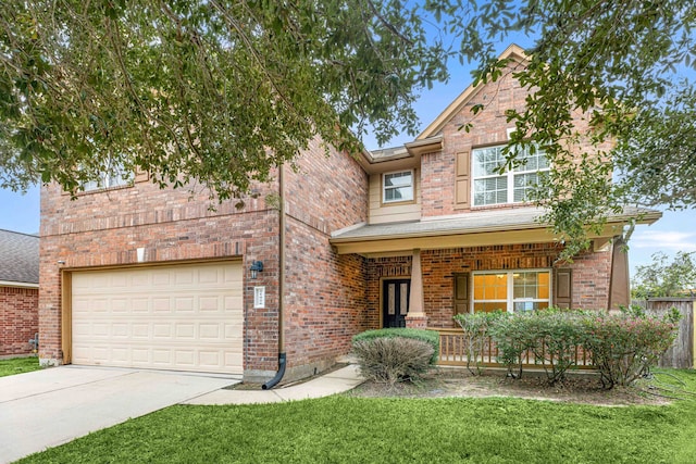 view of front of house featuring a front yard, a porch, and a garage