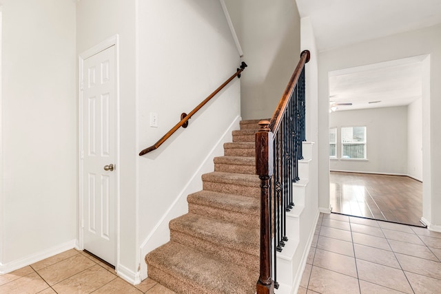 staircase with tile patterned flooring and ceiling fan