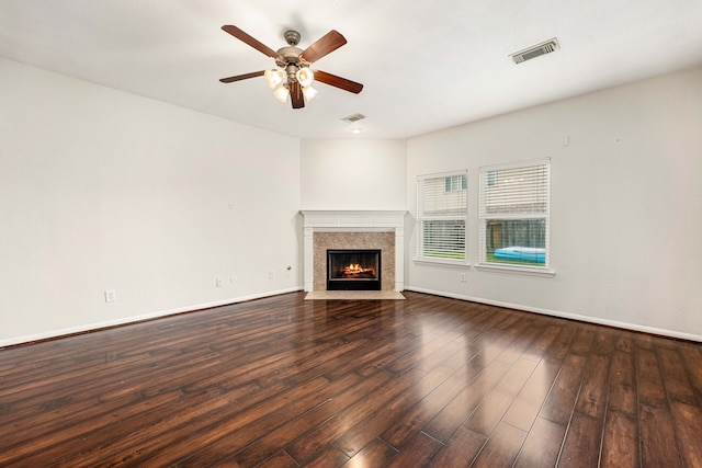 unfurnished living room with ceiling fan, dark hardwood / wood-style flooring, and a fireplace