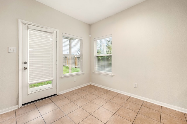 unfurnished room with light tile patterned floors