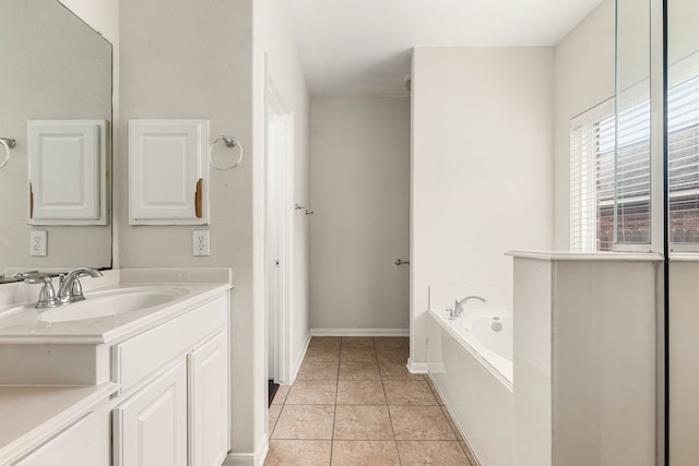 bathroom featuring tile patterned floors, a washtub, and vanity