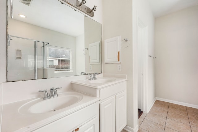 bathroom featuring tile patterned flooring, vanity, and a shower with shower door