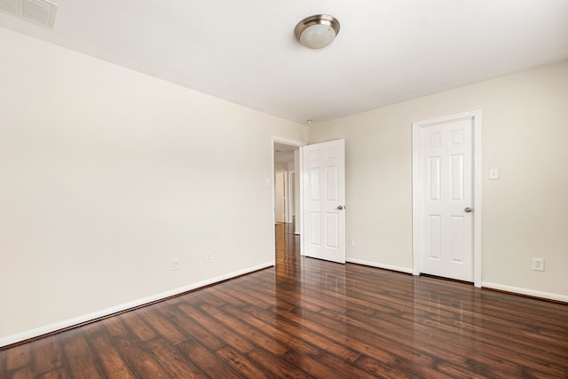 spare room with dark hardwood / wood-style floors