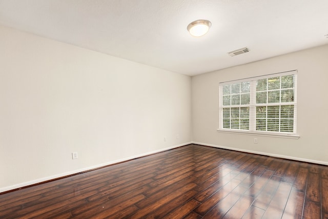 empty room with dark wood-type flooring