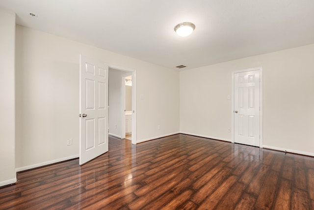 unfurnished room featuring dark hardwood / wood-style floors