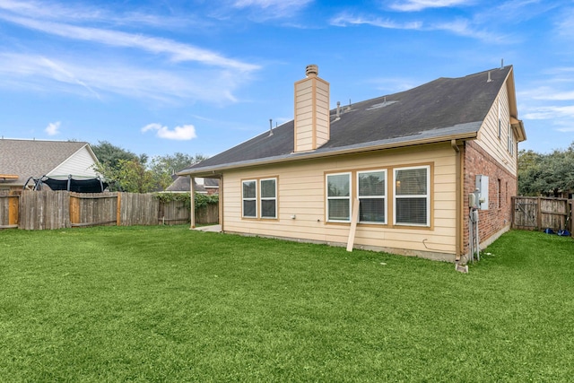 back of house with a lawn