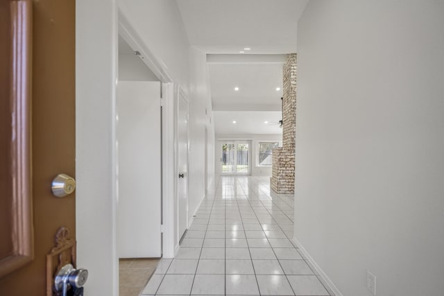 corridor featuring light tile patterned floors