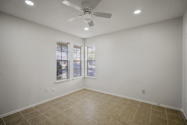 spare room featuring ceiling fan and a textured ceiling