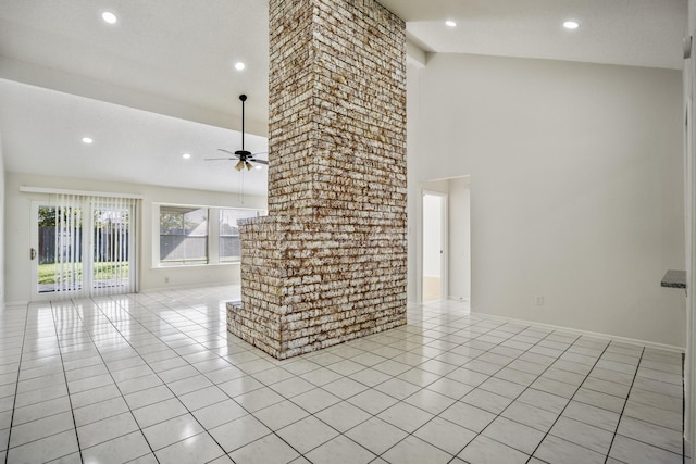 unfurnished living room with ceiling fan, light tile patterned floors, a textured ceiling, and high vaulted ceiling