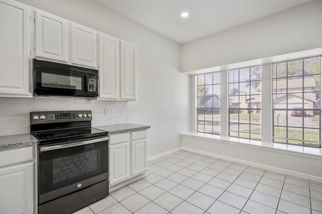 kitchen with white cabinetry, stainless steel electric range oven, tasteful backsplash, and light tile patterned flooring