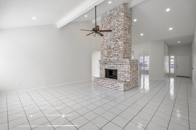 unfurnished living room featuring a brick fireplace, ceiling fan, light tile patterned floors, a textured ceiling, and beam ceiling