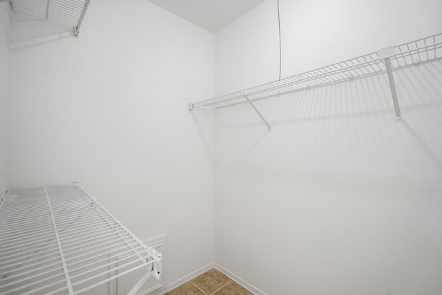 walk in closet with tile patterned floors