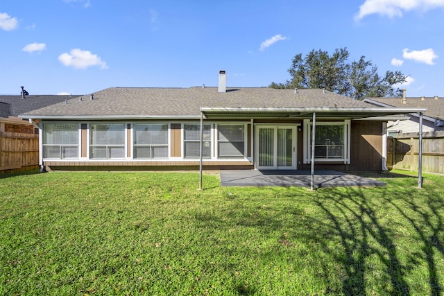 back of property featuring a lawn and a patio