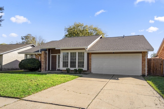 single story home with a garage and a front yard