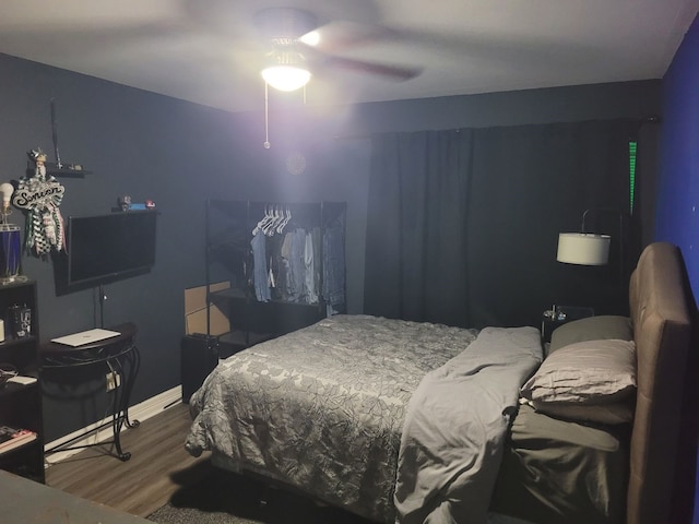 bedroom with hardwood / wood-style flooring and ceiling fan