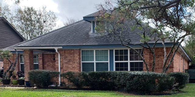 view of home's exterior with a yard