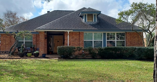 rear view of house featuring a yard