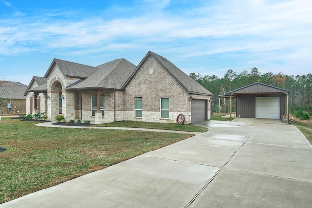 view of front of house featuring a front lawn, a carport, an outdoor structure, and a garage