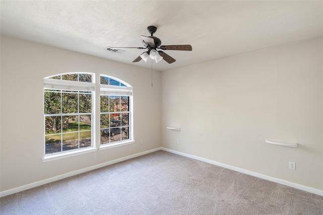 empty room with ceiling fan and carpet floors