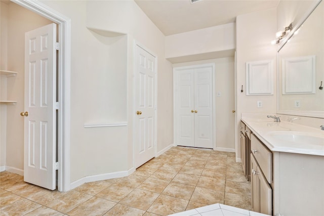 bathroom with tile patterned flooring and vanity