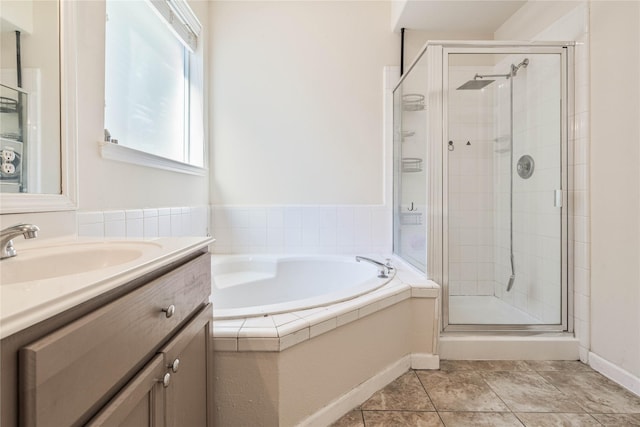 bathroom featuring vanity and independent shower and bath