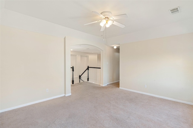 carpeted spare room featuring ceiling fan