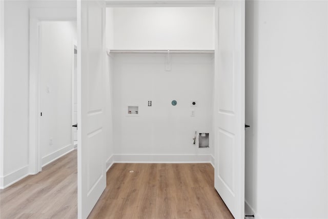 washroom with hookup for an electric dryer, hookup for a washing machine, light wood-type flooring, and hookup for a gas dryer