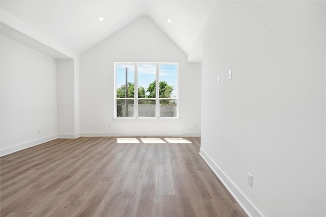 interior space featuring light wood-type flooring and high vaulted ceiling