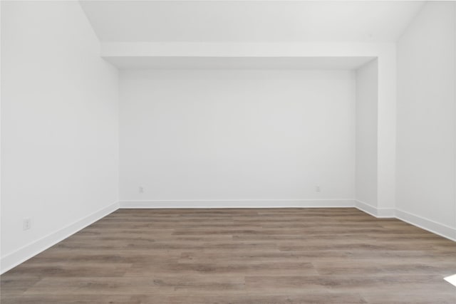 unfurnished room with hardwood / wood-style flooring