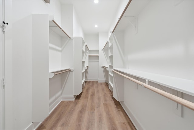 spacious closet with light hardwood / wood-style flooring