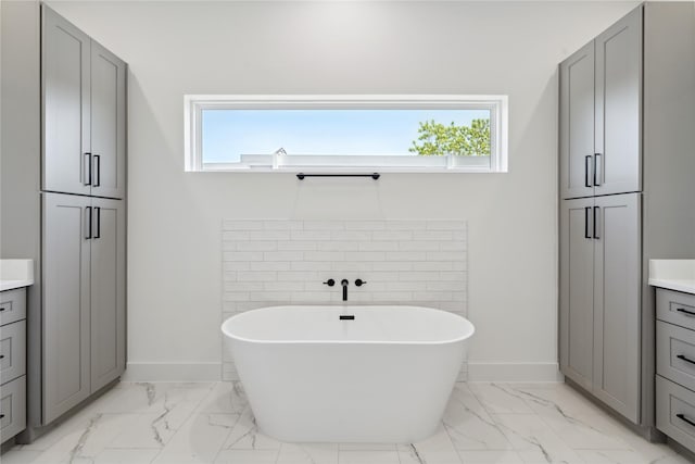 bathroom featuring vanity and a tub