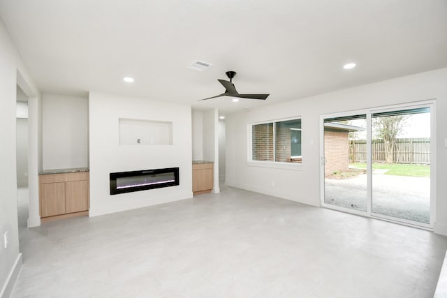 unfurnished living room featuring ceiling fan