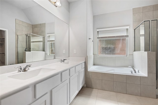 bathroom featuring tile patterned flooring, vanity, vaulted ceiling, and plus walk in shower