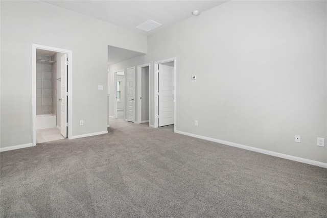 unfurnished bedroom with ensuite bathroom and light colored carpet