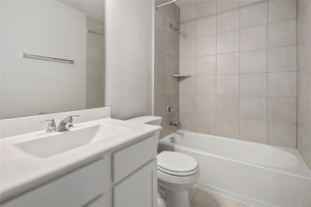 full bathroom with tile patterned flooring, tiled shower / bath combo, toilet, and vanity