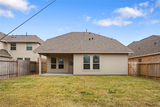 rear view of house with a lawn and a patio