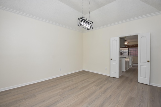 unfurnished dining area with a textured ceiling, crown molding, vaulted ceiling, and hardwood / wood-style flooring