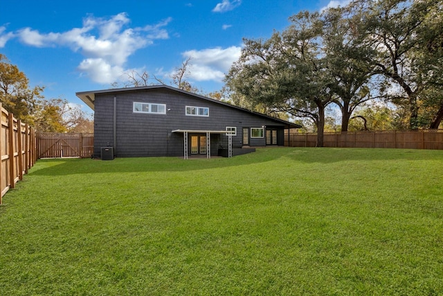 back of property with a lawn and central air condition unit