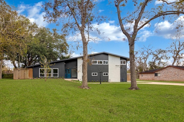 rear view of house featuring a yard